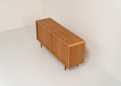 Oak sideboard with tambour doors by Kibaek Møbelfabrik (Denmark, 1960s). A beautifully crafted piece showcasing exceptional Danish design and craftsmanship. It features two tambour doors with adjustable shelves and two drawers on the inside, offering generous and flexible storage. The softly rounded edges and organic lines give the sideboard a refined, timeless character. In good condition with a mark/stain on top.
