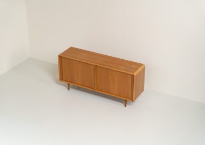 Oak sideboard with tambour doors by Kibaek Møbelfabrik (Denmark, 1960s). A beautifully crafted piece showcasing exceptional Danish design and craftsmanship. It features two tambour doors with adjustable shelves and two drawers on the inside, offering generous and flexible storage. The softly rounded edges and organic lines give the sideboard a refined, timeless character. In good condition with a mark/stain on top.