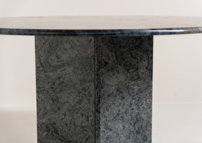 Striking dining table in solid Juparana Granite (Italy, 1970s). A beautifully sculptural piece, crafted entirely from solid Juparana Granite and distinguished by the unbelievably rich and unique grain of its tabletop. The natural variation in the stone gives the surface an almost painterly quality, making each angle of the table slightly different. Large and substantial, yet remarkably minimalistic, the table has a strong monolithic presence. The thick circular top is balanced by a sculptural three-sided pedestal base, creating a striking silhouette while keeping the overall design exceptionally clean. With its generous 130 cm diameter, the table comfortably accommodates up to six chairs. The tabletop and pedestal base are two separate pieces, making transportation and installation considerably easier despite its substantial weight. The table is in amazing condition, with no chips or structural damage.