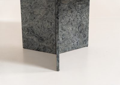 Striking dining table in solid Juparana Granite (Italy, 1970s). A beautifully sculptural piece, crafted entirely from solid Juparana Granite and distinguished by the unbelievably rich and unique grain of its tabletop. The natural variation in the stone gives the surface an almost painterly quality, making each angle of the table slightly different. Large and substantial, yet remarkably minimalistic, the table has a strong monolithic presence. The thick circular top is balanced by a sculptural three-sided pedestal base, creating a striking silhouette while keeping the overall design exceptionally clean. With its generous 130 cm diameter, the table comfortably accommodates up to six chairs. The tabletop and pedestal base are two separate pieces, making transportation and installation considerably easier despite its substantial weight. The table is in amazing condition, with no chips or structural damage.