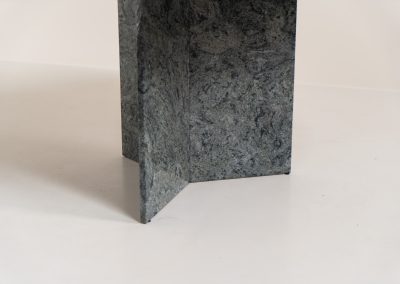 Striking dining table in solid Juparana Granite (Italy, 1970s). A beautifully sculptural piece, crafted entirely from solid Juparana Granite and distinguished by the unbelievably rich and unique grain of its tabletop. The natural variation in the stone gives the surface an almost painterly quality, making each angle of the table slightly different. Large and substantial, yet remarkably minimalistic, the table has a strong monolithic presence. The thick circular top is balanced by a sculptural three-sided pedestal base, creating a striking silhouette while keeping the overall design exceptionally clean. With its generous 130 cm diameter, the table comfortably accommodates up to six chairs. The tabletop and pedestal base are two separate pieces, making transportation and installation considerably easier despite its substantial weight. The table is in amazing condition, with no chips or structural damage.