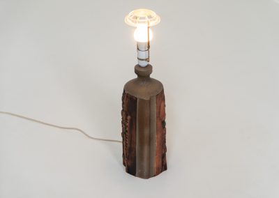 Sculptural “Kennegie” ceramic lamp by Peter Ellery for Tremaen (UK, 1960s). This lamp offers a refined blend of beautiful textures and timeless design. It has a handcrafted ceramic base with earthy colors and graphic engravings. The lamp remains in splendid condition.