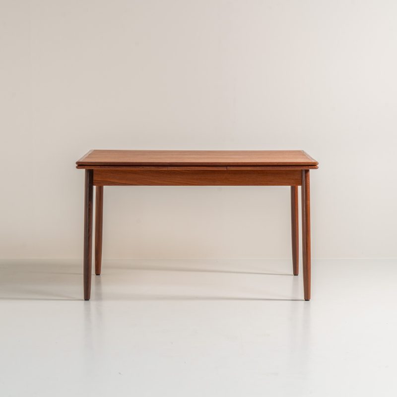 Danish extendable dining table, 1960s. A beautiful Danish extendable dining table that can easily be extended from 126 cm to 174 cm with one extension or to 223 cm with two extensions. The table is in very good condition, features a lovely wood grain and has beautiful tapered legs.
