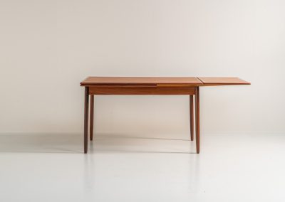 Danish extendable dining table, 1960s. A beautiful Danish extendable dining table that can easily be extended from 126 cm to 174 cm with one extension or to 223 cm with two extensions. The table is in very good condition, features a lovely wood grain and has beautiful tapered legs.