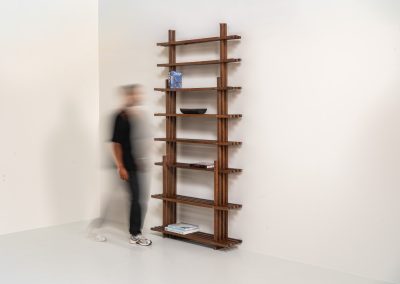 Sculptural wengé slat bookcase (Europe, 1960s). A sculptural bookcase defined by the rhythmic interplay of solid wengé slats and slender vertical supports. Its distinctive stepped construction, tapering towards the top, gives the piece an almost totemic presence. Both a functional piece of furniture and an architectural object. As we have been unable to find any documentation or comparable examples, this may well be a one-of-a-kind piece, reminiscent of the work of Fabrizio Mangoni. The bookcase is in beautiful vintage condition, with minor signs of age and use, including a few slightly warped slats.