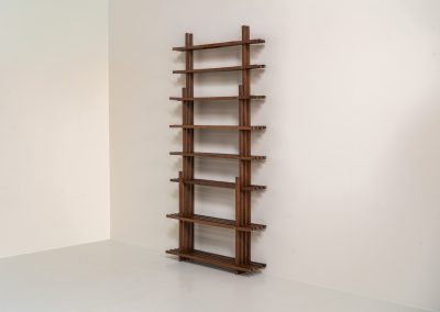 Sculptural wengé slat bookcase (Europe, 1960s). A sculptural bookcase defined by the rhythmic interplay of solid wengé slats and slender vertical supports. Its distinctive stepped construction, tapering towards the top, gives the piece an almost totemic presence. Both a functional piece of furniture and an architectural object. As we have been unable to find any documentation or comparable examples, this may well be a one-of-a-kind piece, reminiscent of the work of Fabrizio Mangoni. The bookcase is in beautiful vintage condition, with minor signs of age and use, including a few slightly warped slats.