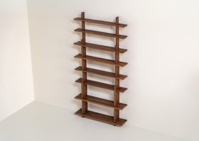 Sculptural wengé slat bookcase (Europe, 1960s). A sculptural bookcase defined by the rhythmic interplay of solid wengé slats and slender vertical supports. Its distinctive stepped construction, tapering towards the top, gives the piece an almost totemic presence. Both a functional piece of furniture and an architectural object. As we have been unable to find any documentation or comparable examples, this may well be a one-of-a-kind piece, reminiscent of the work of Fabrizio Mangoni. The bookcase is in beautiful vintage condition, with minor signs of age and use, including a few slightly warped slats.