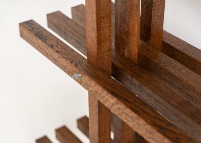 Sculptural wengé slat bookcase (Europe, 1960s). A sculptural bookcase defined by the rhythmic interplay of solid wengé slats and slender vertical supports. Its distinctive stepped construction, tapering towards the top, gives the piece an almost totemic presence. Both a functional piece of furniture and an architectural object. As we have been unable to find any documentation or comparable examples, this may well be a one-of-a-kind piece, reminiscent of the work of Fabrizio Mangoni. The bookcase is in beautiful vintage condition, with minor signs of age and use, including a few slightly warped slats.