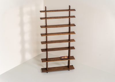 Sculptural wengé slat bookcase (Europe, 1960s). A sculptural bookcase defined by the rhythmic interplay of solid wengé slats and slender vertical supports. Its distinctive stepped construction, tapering towards the top, gives the piece an almost totemic presence. Both a functional piece of furniture and an architectural object. As we have been unable to find any documentation or comparable examples, this may well be a one-of-a-kind piece, reminiscent of the work of Fabrizio Mangoni. The bookcase is in beautiful vintage condition, with minor signs of age and use, including a few slightly warped slats.