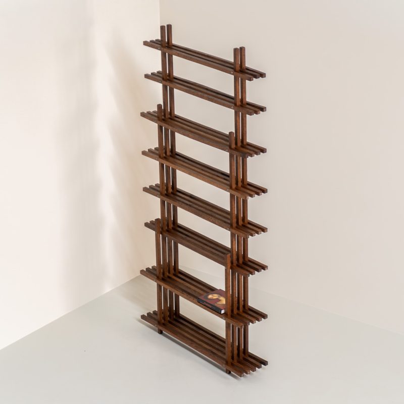 Sculptural wengé slat bookcase (Europe, 1960s). A sculptural bookcase defined by the rhythmic interplay of solid wengé slats and slender vertical supports. Its distinctive stepped construction, tapering towards the top, gives the piece an almost totemic presence. Both a functional piece of furniture and an architectural object. As we have been unable to find any documentation or comparable examples, this may well be a one-of-a-kind piece, reminiscent of the work of Fabrizio Mangoni. The bookcase is in beautiful vintage condition, with minor signs of age and use, including a few slightly warped slats.