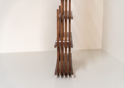 Sculptural wengé slat bookcase (Europe, 1960s). A sculptural bookcase defined by the rhythmic interplay of solid wengé slats and slender vertical supports. Its distinctive stepped construction, tapering towards the top, gives the piece an almost totemic presence. Both a functional piece of furniture and an architectural object. As we have been unable to find any documentation or comparable examples, this may well be a one-of-a-kind piece, reminiscent of the work of Fabrizio Mangoni. The bookcase is in beautiful vintage condition, with minor signs of age and use, including a few slightly warped slats.