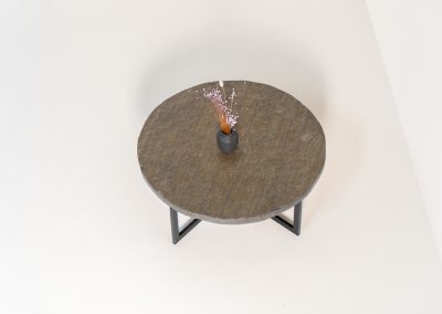 Coffee Table in Norwegian Slate stone, 1970s A very powerful brutalist coffee table from the 1970s, defined by its strong architectural presence and sculptural simplicity. The substantial tabletop is crafted from Norwegian slate, showcasing a rich and varied surface with natural tonal shifts that create depth and visual texture. The solid stone top is supported by a black lacquered metal base, offering a bold contrast while reinforcing the table’s grounded and monolithic character. The table remains in very good condition, with light, age-appropriate wear such as minor scratches to the frame.