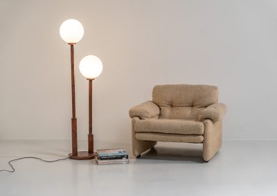 Wood & opal glass floor lamp, 1970s. Vintage floor lamp featuring a sculptural, geometric wooden base with two slender stems at different heights, each topped with a spherical opaline glass shade. The warm-toned wood and softly diffused light create a beautiful balance between architectural form and understated elegance. A distinctive vintage piece that works as both a functional light source and a sculptural accent in a contemporary or mid-century inspired interior. The lamp is in very good vintage condition overall, with a subtle historic repair to the wood near the base of one glass support.