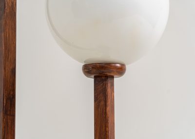 Wood & opal glass floor lamp, 1970s. Vintage floor lamp featuring a sculptural, geometric wooden base with two slender stems at different heights, each topped with a spherical opaline glass shade. The warm-toned wood and softly diffused light create a beautiful balance between architectural form and understated elegance. A distinctive vintage piece that works as both a functional light source and a sculptural accent in a contemporary or mid-century inspired interior. The lamp is in very good vintage condition overall, with a subtle historic repair to the wood near the base of one glass support.