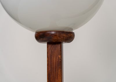 Wood & opal glass floor lamp, 1970s. Vintage floor lamp featuring a sculptural, geometric wooden base with two slender stems at different heights, each topped with a spherical opaline glass shade. The warm-toned wood and softly diffused light create a beautiful balance between architectural form and understated elegance. A distinctive vintage piece that works as both a functional light source and a sculptural accent in a contemporary or mid-century inspired interior. The lamp is in very good vintage condition overall, with a subtle historic repair to the wood near the base of one glass support.